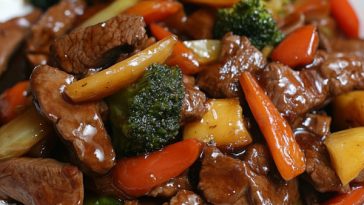 Beef stir fry with vegetables in honey pepper sauce served in a wok
