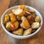Crispy Southern air-fried potatoes with golden edges, seasoned with herbs and spices, served hot and crunchy.
