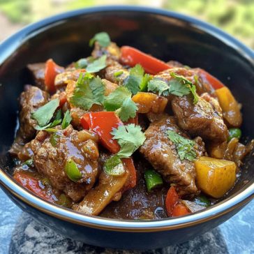 Xinjiang cumin lamb stir fry with sliced lamb, cumin spices, red chilies, and onions in a wok.