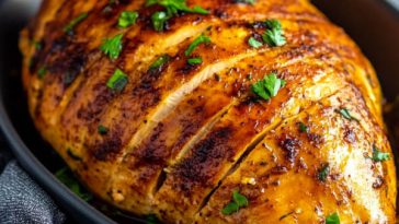 Slow cooker turkey breast sliced and served with herbs