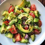 Avocado Salad Recipe with ripe avocado slices, cherry tomatoes, red onion, cucumber, and fresh herbs tossed in a light dressing.