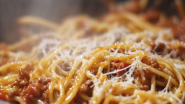 Hearty one pot pasta Bolognese cooked in a rich tomato and ground beef sauce, simmered together in a single pan and topped with grated parmesan cheese.
