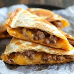 Crispy Oven Baked Quesadillas Recipe with golden-brown tortilla, melted cheese, and savory fillings served on a plate.