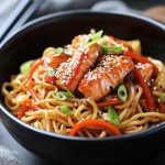 Teriyaki salmon noodles with glazed salmon fillet, stir‑fried vegetables, and sesame seeds served in a bowl