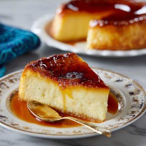 Classic French flan pâtissier with a golden pastry crust and creamy vanilla custard filling, sliced and served on a plate.
