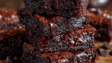 Light and chocolaty brownies cut into squares, with a soft texture and rich cocoa flavor, served on a plate with a dusting of powdered sugar.