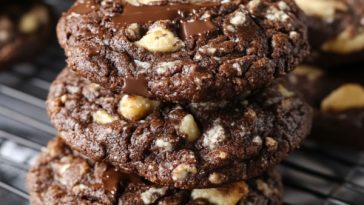 German chocolate cookies topped with gooey coconut‑pecan frosting and drizzled with melted chocolate.