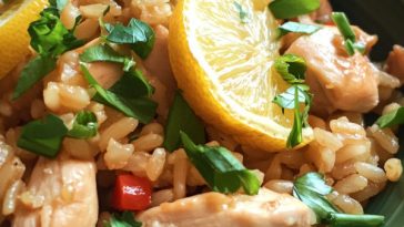 One‑pot chicken and rice with caramelized lemon slices, fresh herbs, and golden rice served in a skillet.