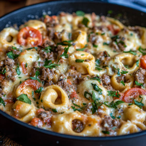 “Cheesesteak tortellini tossed in a creamy provolone sauce with tender beef strips and peppers, served in a skillet.”