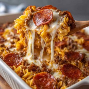 “A cheesy meat lovers pizza casserole baked with layers of pasta, marinara sauce, pepperoni, sausage, and melted mozzarella.”