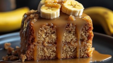 “A moist banana cake drizzled with golden caramel sauce, topped with whipped cream and sliced bananas.”