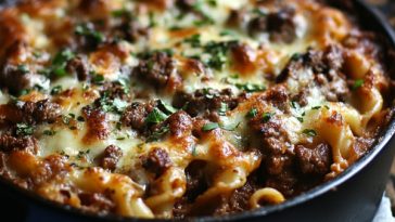 “A baked beef Lombardi casserole layered with ground beef, tomato sauce, noodles, sour cream, and melted cheese.”