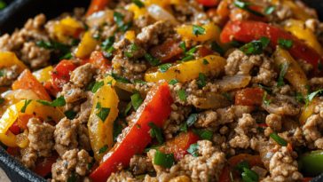 “A skillet of ground turkey cooked with colorful bell peppers, onions, and herbs, served as a healthy dinner.”