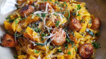 Delicious autumn sausage pasta squash with roasted butternut squash, savory sausage, pasta shells, and fresh herbs in a creamy sauce, served in a rustic bowl.