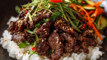 Thinly sliced marinated Korean beef bulgogi grilled to perfection, served with sesame seeds, scallions, and steamed rice.