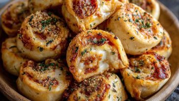 Golden New York-style pizza rolls stuffed with melted mozzarella, brushed with garlic butter, and served warm on a tray.