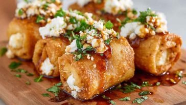 Crispy oven fried feta rolls drizzled with chili honey on a serving plate