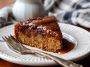 Moist Amish applesauce cake topped with glaze and sprinkled with cinnamon on a rustic serving plate.