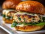 Grilled chicken burgers with melted white cheddar and spinach, served on toasted buns with lettuce and aioli.