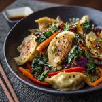 Potsticker stir fry with vegetables and sesame seeds in a skillet