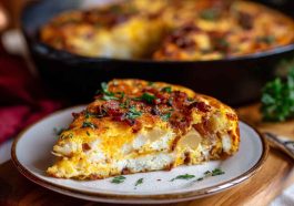 Ina Garten’s bacon potato frittata baked golden in a skillet, filled with crispy bacon, tender potatoes, and melted cheese.