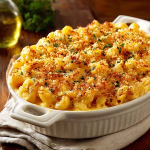 Southern-style baked mac and cheese with golden crust, creamy cheese sauce, and elbow pasta served in a casserole dish.