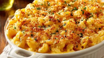 Southern-style baked mac and cheese with golden crust, creamy cheese sauce, and elbow pasta served in a casserole dish.