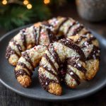 Magical candy cane cookies shaped with swirls of red and white dough, sprinkled with sugar, and arranged festively on a holiday plate.