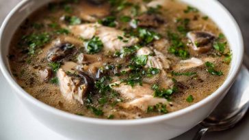 Clean chicken mushroom soup with tender chicken pieces, earthy mushrooms, carrots, and herbs simmered in a clear broth.