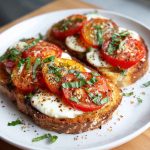 Tomato basil mozzarella toast topped with balsamic glaze on a wooden board
