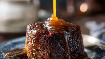 Decadent sticky toffee pudding drizzled with rich caramel sauce, served warm with a scoop of vanilla ice cream.