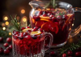 Midnight Frost Christmas punch served in a festive glass bowl with sparkling cranberries, citrus slices, and frosty garnish.