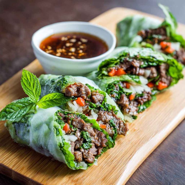 Rice paper rolls filled with Thai basil beef, cucumbers, and herbs, served with chili-lime dipping sauce.