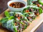 Rice paper rolls filled with Thai basil beef, cucumbers, and herbs, served with chili-lime dipping sauce.