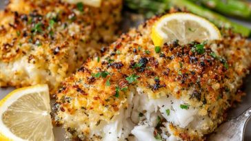 Crispy air fryer parmesan cod fillets with golden breading, served with lemon wedges and fresh herbs.