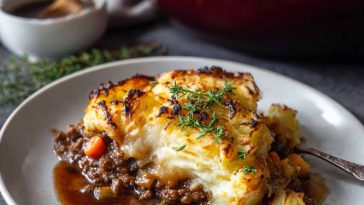 Cozy winter shepherd’s pie topped with golden mashed potatoes, baked in a casserole dish with savory beef and vegetables.
