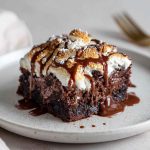 Rich and gooey chocolate earthquake cake with swirls of cream cheese, chocolate chips, and a fudgy center.