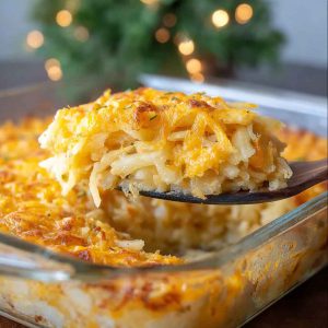 A bubbling cheesy potato casserole with golden crust, creamy layers, and a sprinkle of fresh herbs on top.