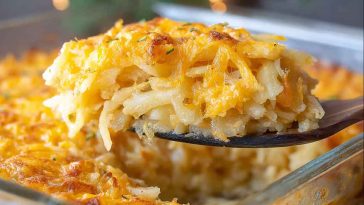 A bubbling cheesy potato casserole with golden crust, creamy layers, and a sprinkle of fresh herbs on top.