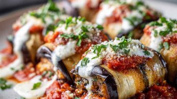 Rolled slices of roasted eggplant stuffed with ricotta and herbs, topped with marinara and melted mozzarella.