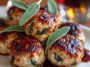 Golden turkey meatballs with apple and sage served on a rustic plate with herbs and cider glaze.
