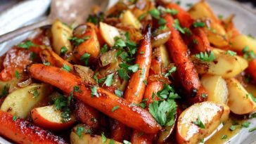 Autumn Bliss maple dijon roasted apples and carrots on a rustic baking tray, caramelized and garnished with fresh herbs.