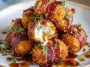 Crispy bacon-wrapped cheese balls stacked