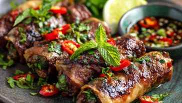 Thai basil beef rolls wrapped in rice paper with fresh herbs and dipping sauce