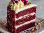 Slice of red velvet cheesecake layer cake with cream cheese frosting