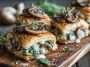 Creamy mushroom and spinach stuffed pastry bites baked golden brown, filled with savory mushroom, spinach, and cream cheese mixture.