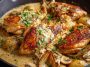 Skillet of Irish chicken in whiskey cream sauce garnished with fresh herbs