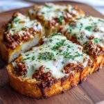 Cheesy sloppy joe garlic bread topped with melted cheese and parsley