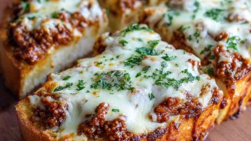 Cheesy sloppy joe garlic bread topped with melted cheese and parsley