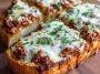 Cheesy sloppy joe garlic bread topped with melted cheese and parsley